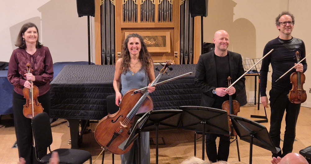 The Carducci String Quartet stand in a row whilst enjoying well-deserved applause
